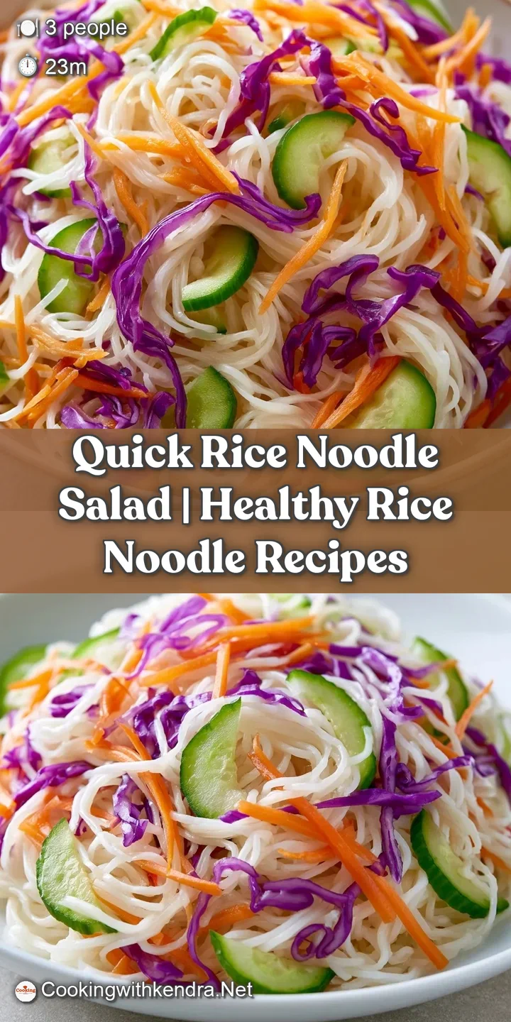 Close-up of glossy rice noodles glistening with a light vinaigrette and garnished with crushed toasted peanuts.
