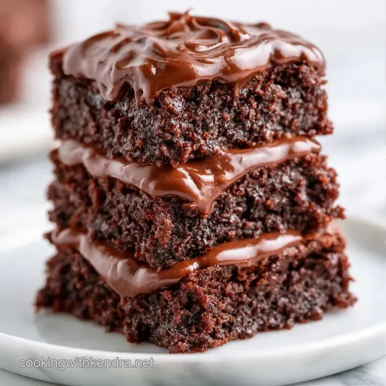 A square of moist dark cocoa cake dusted with powder, served on a slate plate with a dollop of whipped cream.