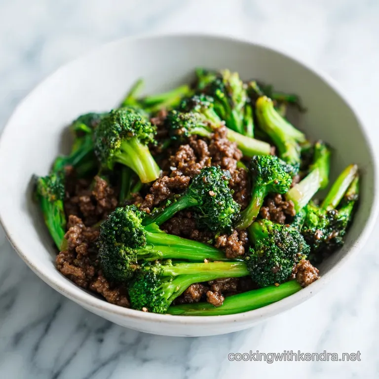 Beef and broccoli elegantly plated, garnished with sesame seeds and scallions; sauce pools invitingly on a white plate.
